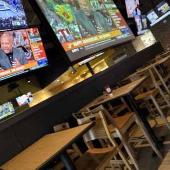 Buffalo Wild Wings - televisions and tables in a restaurant - American Near Me - Houston, Texas