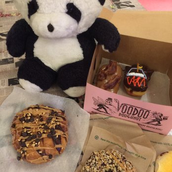 Voodoo Doughnut - Getting his hand into the magic pink box. - Donuts Near Me - Austin, Texas Voodoo Doughnut - Getting his hand into the magic pink box. - Donuts Near Me - Austin, Texas