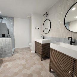 a bathroom with two sinks and a shower a bathroom with two sinks and a shower