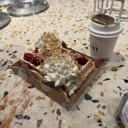 Belgian waffle with cooked strawberries, whipped cream and hazelnuts with cappuccino! Belgian waffle with cooked strawberries, whipped cream and hazelnuts with cappuccino!
