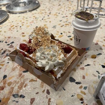 Maison Dandoy - Belgian waffle with cooked strawberries, whipped cream and hazelnuts with cappuccino! - Bakeries Near Me - Brussels, BRU Maison Dandoy - Belgian waffle with cooked strawberries, whipped cream and hazelnuts with cappuccino! - Bakeries Near Me - Brussels, BRU