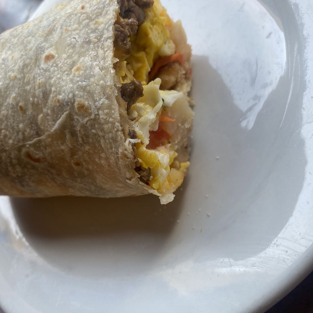 Half of the breakfast burrito with carne asada. Half of the breakfast burrito with carne asada.