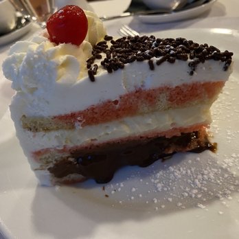 Carmelo's - Yummy cake with blueberry sauce - Italian Near Me - Punta Gorda, Florida