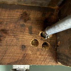Handy Electrician - These are ceiling joists that his jguy drilled 3 holes in before getting it to work. These are exposed joists--it looks like shit.