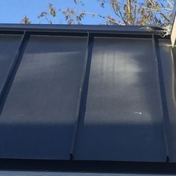 Palm Harbor Homes - White overspray over black metal roof