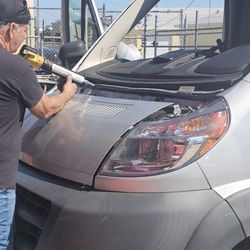 Phoenix Auto Glass - APPLING URETHANE TO THE PINCHWELL ON THIS VAN .  @ JOB SITE