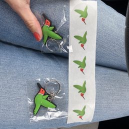 a person holding a pair of scissors a person holding a pair of scissors