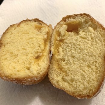 Starbread Bakery - (WTF - "Where's the filling?") Cross section of a Mango Malasada - Bakeries Near Me - Roseville, California