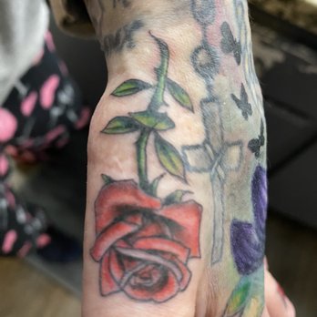 Fullerton Tattoo - New Rose Tattoo; Lotus cover up on top of hand - Piercing Near Me - Fullerton, California