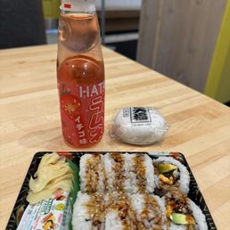 Eel, avocado and cream cheese roll. A daifuku bun and a ramune drink. Eel, avocado and cream cheese roll. A daifuku bun and a ramune drink.