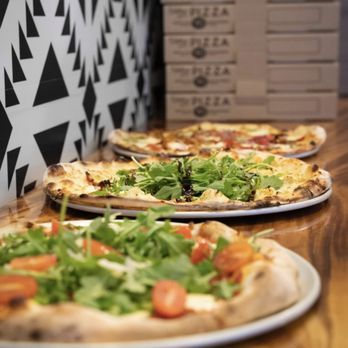 Pizzeria Bros - three pizzas on a table - Pizza Near Me - Edmonton, Alberta Pizzeria Bros - three pizzas on a table - Pizza Near Me - Edmonton, Alberta