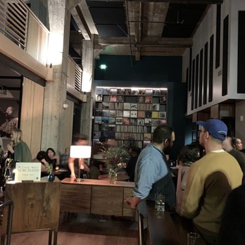 Bar Shiru - Entry way with a wall of vinyl. - Cocktail Bars Near Me - Oakland, California