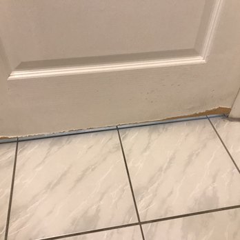Clarion Inn & Suites Central Clearwater Beach - Bathroom door worn and peeling at bottom - Hotels Near Me - Clearwater, Florida
