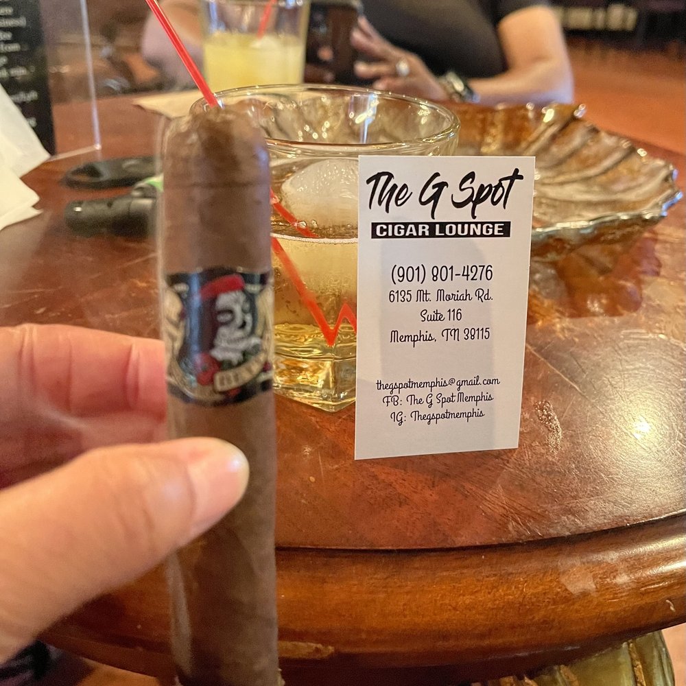 The G Spot - a hand holding a cigar - Cigar Bars Near Me - Memphis, Tennessee The G Spot - a hand holding a cigar - Cigar Bars Near Me - Memphis, Tennessee