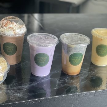 Mango House Cafe - (Left to right) Rice crispy treat, mocha frappe, taro latte, Vietnamese black sesame coffee, mango smoothie - Themed Cafes Near Me - Des Plaines, Illinois