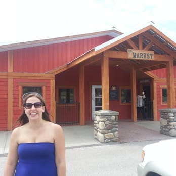 Hopkins Harvest's Market - a woman standing in front of a building - Grocery Near Me - Windermere, British Columbia Hopkins Harvest's Market - a woman standing in front of a building - Grocery Near Me - Windermere, British Columbia