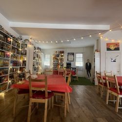 last place on earth - Many shelves of games; tables and chairs used to play them