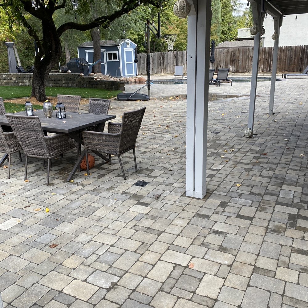 LR Landscaping & Pavers - a patio with a table and chairs - Landscaping Near Me LR Landscaping & Pavers - a patio with a table and chairs - Landscaping Near Me