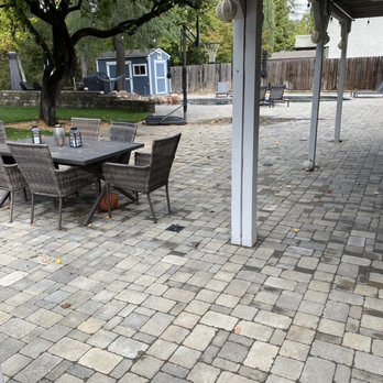 LR Landscaping & Pavers - a patio with a table and chairs - Landscaping Near Me LR Landscaping & Pavers - a patio with a table and chairs - Landscaping Near Me