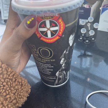 Firehouse Subs - a hand holding a cup of coffee - Sandwiches Near Me - Lawrence, Kansas