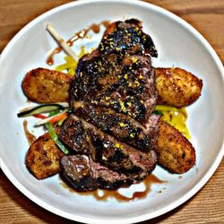 Joey's Spot - 32day Day Aged Ribeye Topped with a Pomegranate Buerre Rouge, Asian Slaw, Mashed Potato croquetta, zested juniper berry cured egg yolk