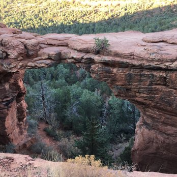 Devil's Bridge Trail - Devils Bridge. The green you see is through the hole made by the overpass. Get started early. - Hiking Near Me - Sedona, Arizona Devil's Bridge Trail - Devils Bridge. The green you see is through the hole made by the overpass. Get started early. - Hiking Near Me - Sedona, Arizona