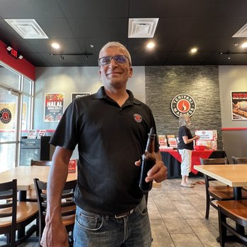Teriyaki Madness - Nik the owner coming around to deliver our hot entrees - Japanese Near Me - Lombard, Illinois