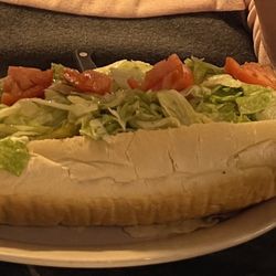 Oscar's Restaurant - Cheesesteak sandwich with plenty of meat below the lettuce and tomato.