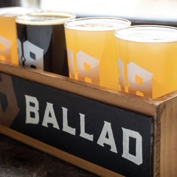 Ballad Brewing - a row of beer glasses in a wooden holder - Breweries Near Me - Danville, Virginia Ballad Brewing - a row of beer glasses in a wooden holder - Breweries Near Me - Danville, Virginia