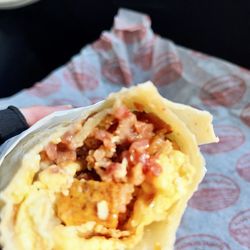 Wheat Montana Bakery & Deli - A fuzzy photo of our magnificent Big Belt Breakfast Wrap (sorry). Filled with bacon, potatoes, sausage gravy, & eggs.