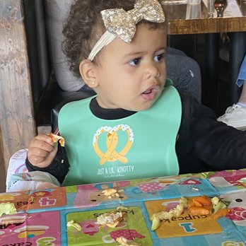 Konnichiwa - Happy Customer enjoying her salmon. - Sushi Bars Near Me - Lexington, South Carolina