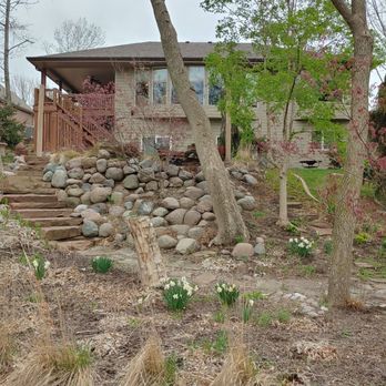 Vinny's Tree Service - Leaning tree and hill of boulders - Tree Services Near Me - Omaha, Nebraska