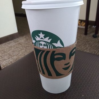 Starbucks - a starbucks cup on a table - Coffee & Tea Near Me - Warner Robins, Georgia