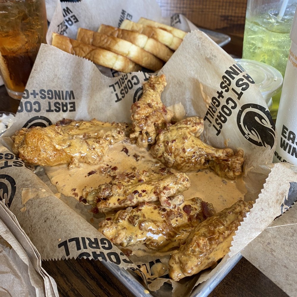 a tray of fried wings and fries