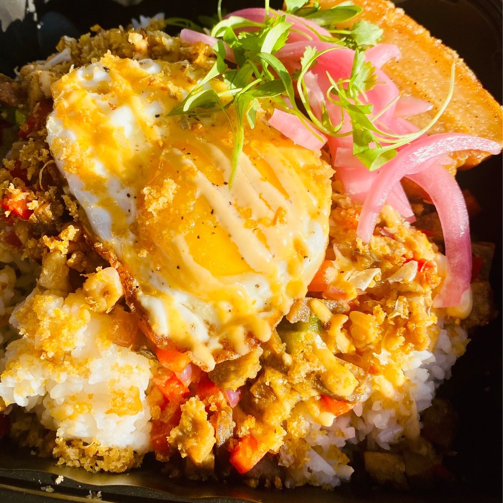 Pork Sisig with Crispy Pork Belly ,fried egg , pickled onions Pork Sisig with Crispy Pork Belly ,fried egg , pickled onions