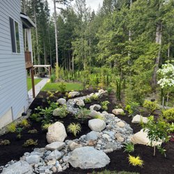 Universal Landscape - Dry rock river bed, trees, plants and plant bed. Outcropping rocks.