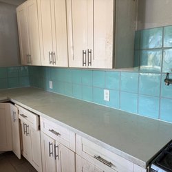 Construction Hub - Same kitchen, teal tile along the whole counter and around every outlet.