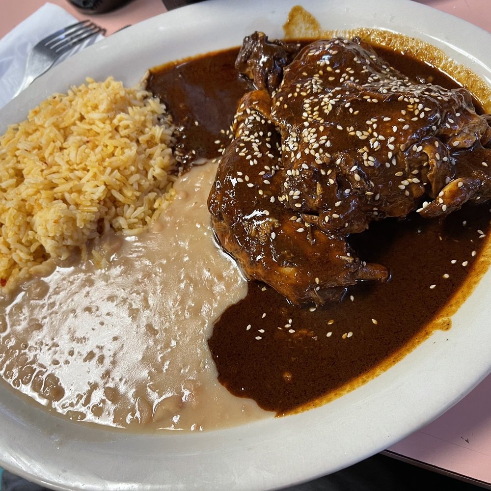 Pollo en mole rojo. Chicken with red mole sauce. Pollo en mole rojo. Chicken with red mole sauce.