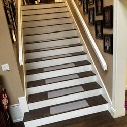 FS Flooring and Remodeling - Stairskirt / white risers / laminate treads install / painted semi gloss for the fine finish.
