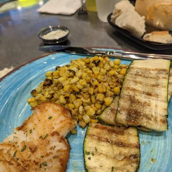 Simply Fish Seafood - Chilean sea bass (blackened Cajun; $26) with zucchini and roasted corn - Fish & Chips Near Me - Costa Mesa, California Simply Fish Seafood - Chilean sea bass (blackened Cajun; $26) with zucchini and roasted corn - Fish & Chips Near Me - Costa Mesa, California