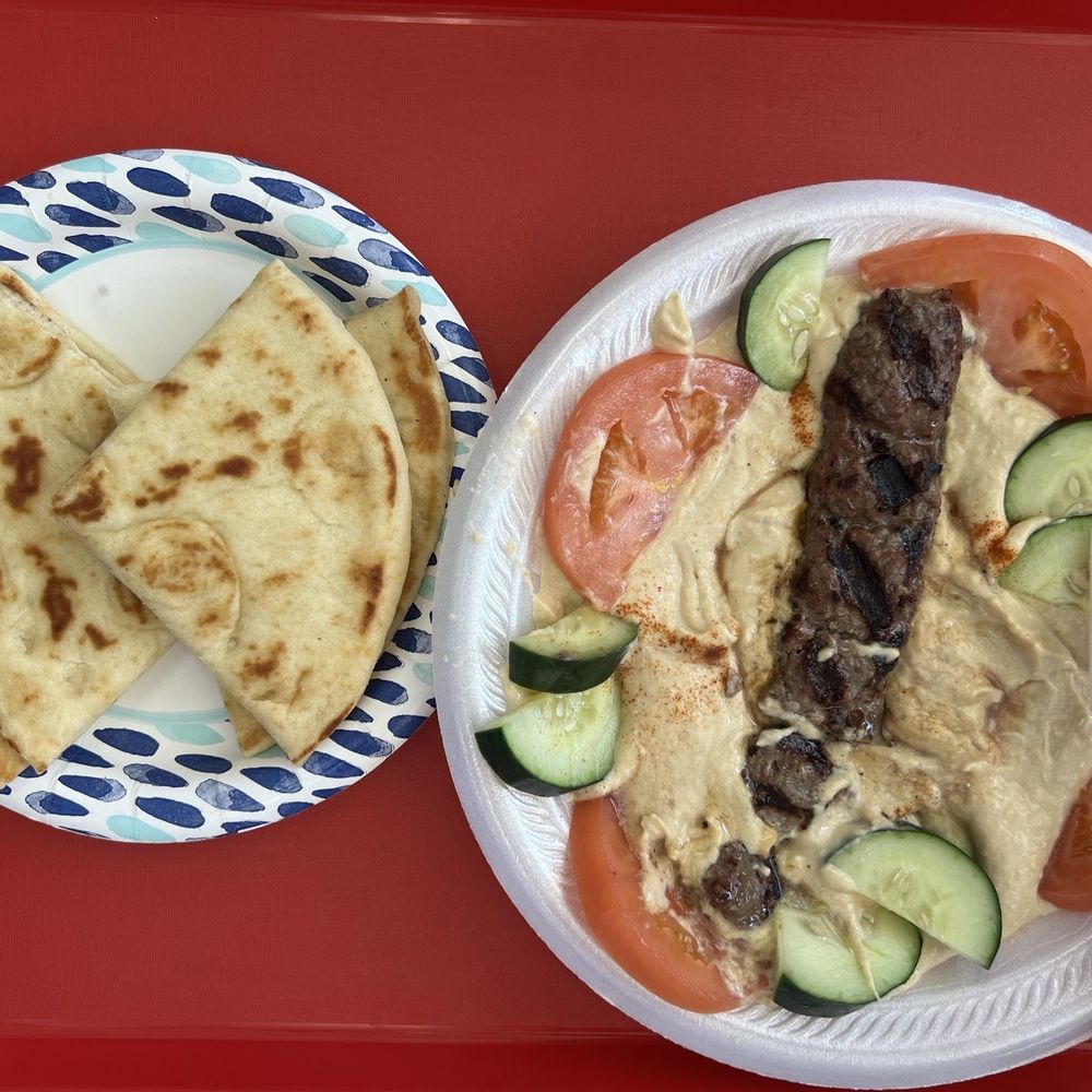 Hummus, kefta kabob, tomato, cucumber, and pita bread Hummus, kefta kabob, tomato, cucumber, and pita bread