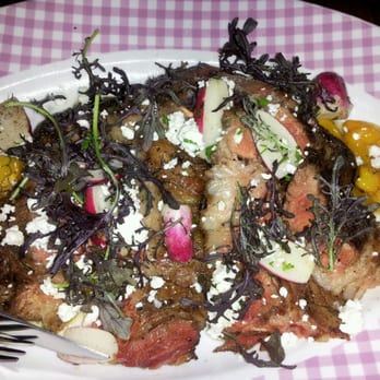 The Publican - 60 days old ribeye sliced on a large platter. - New American Near Me - Chicago, Illinois