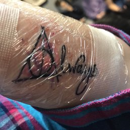 I will update with better photo later but it's a Harry Potter deathly hallows symbol with water color that says always by Steven Jackson