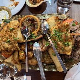 Platter with beef and chicken kebab, filo pastry, lamp chop, rice and faro, etc Platter with beef and chicken kebab, filo pastry, lamp chop, rice and faro, etc