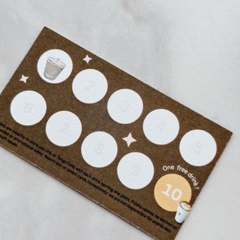 Tangy Cafe - A coffee loyalty card with ten empty circles, a coffee cup icon, and a note about earning points, placed on a white surface. - Cafes Near Me - Markham, Ontario