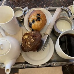 Tea and a blueberry muffin and coffee with a heart healthy muffin. Tea and a blueberry muffin and coffee with a heart healthy muffin.