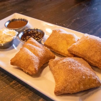Pizza Rock - Zeppole : Fried Pizza Dough, Cinnamon-Sugar, Cardamom, Caramel, Chocolate Sauce w/ Citrus Whipped Cream. Light & fluffy bread, mostly hollow - Pizza Near Me - Henderson, Nevada