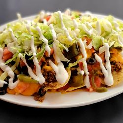 Tall Pines Players Club - ULTIMATE NACHOS                             Spicy ground beef, cheese, jalapeños, black olives, lettuce, tomatoes, guacamole & sour cream