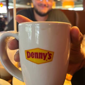 Denny's - a man holding a cup of coffee - American Near Me - Buena Park, California