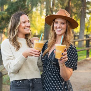 Nekter Juice Bar - two women holding drinks - Juice Bars & Smoothies Near Me - Encinitas, California Nekter Juice Bar - two women holding drinks - Juice Bars & Smoothies Near Me - Encinitas, California